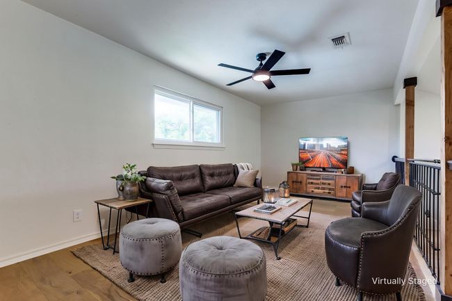 Living room featuring a ceiling fan and wood finished floors | Image 12