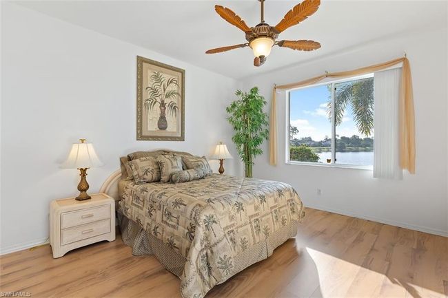 Bedroom with ceiling fan, hardwood / wood-style flooring, and a water view | Image 16
