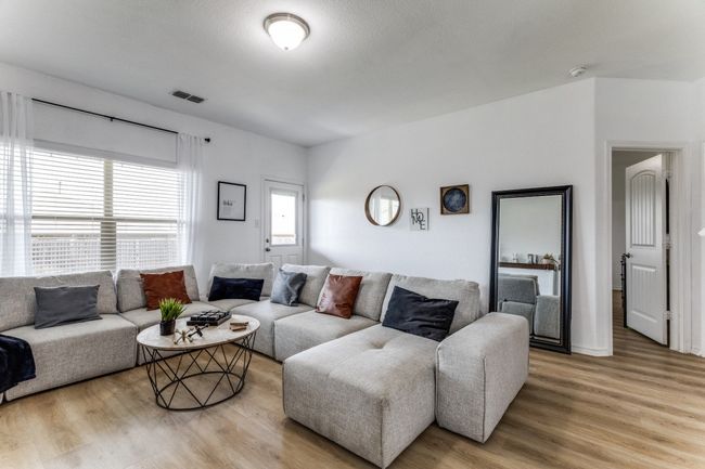 Living room with light wood-style flooring | Image 8
