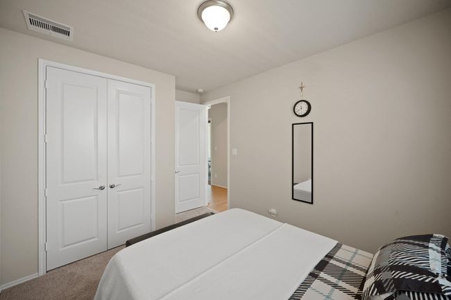 Fourth bedroom features largewindows and plush carpet. | Image 32