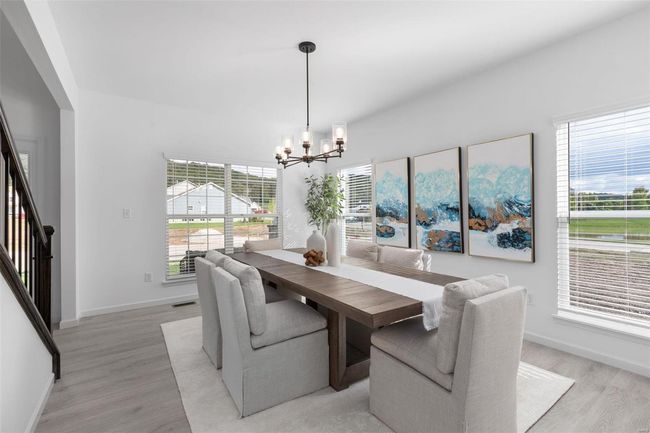 Dining space featuring a notable chandelier, light hardwood / wood-style flooring, and a wealth of natural light | Image 15