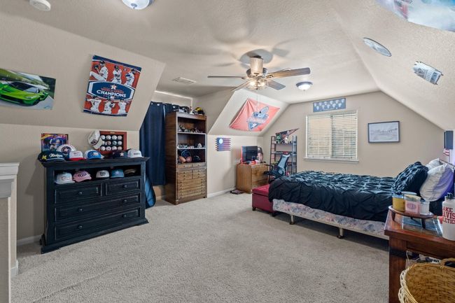 Bonus Room featuring a textured ceiling, carpet flooring, a ceiling fan, and vaulted ceiling | Image 29