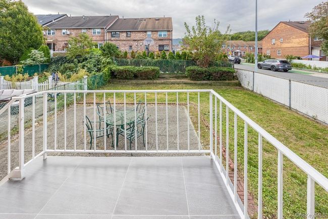 Balcony with a residential view and outdoor dining space | Image 10
