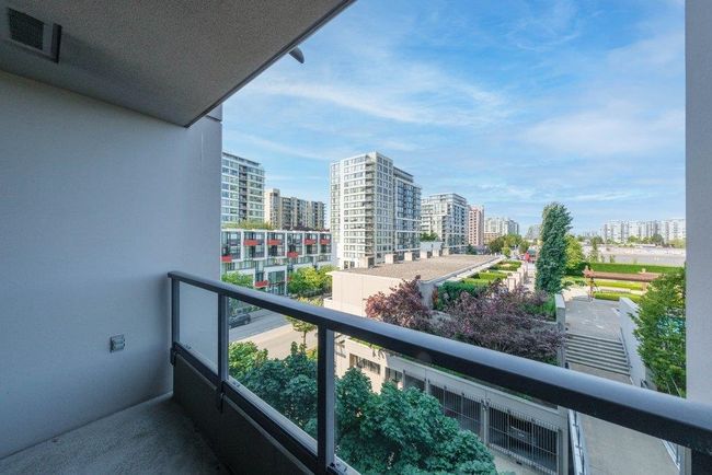 Balcony featuring visible vents and a view of city | Image 21