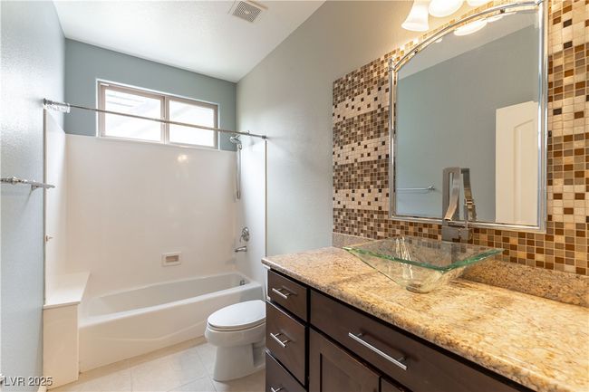 Full bathroom with toilet, tasteful backsplash, washtub / shower combination, and visible vents | Image 18