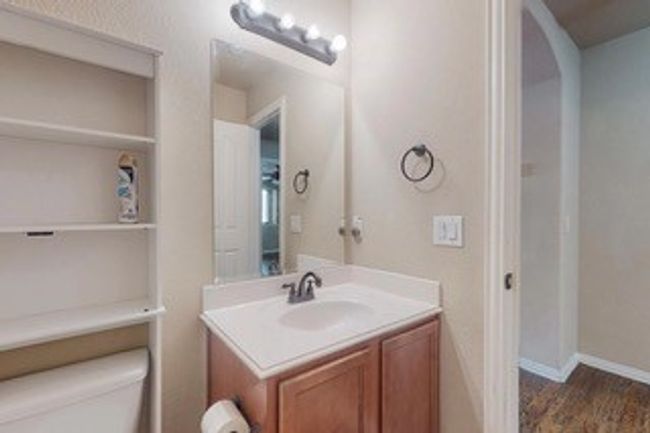 Half bathroom featuring vanity and wood finished floors | Image 17