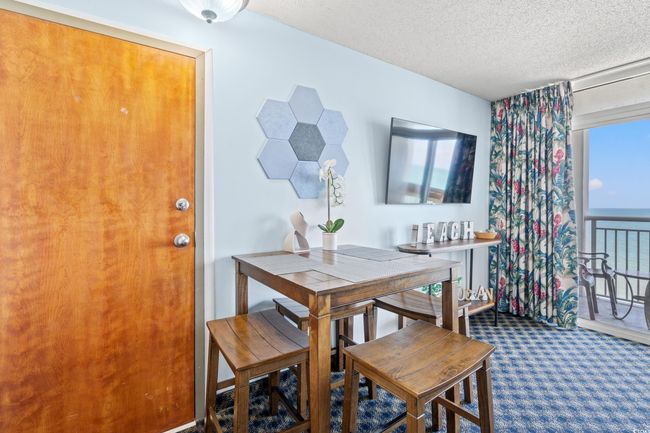Carpeted dining room featuring a textured ceiling | Image 21
