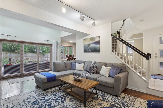 Living area with rail lighting, stairway, and hardwood / wood-style flooring | Image 9