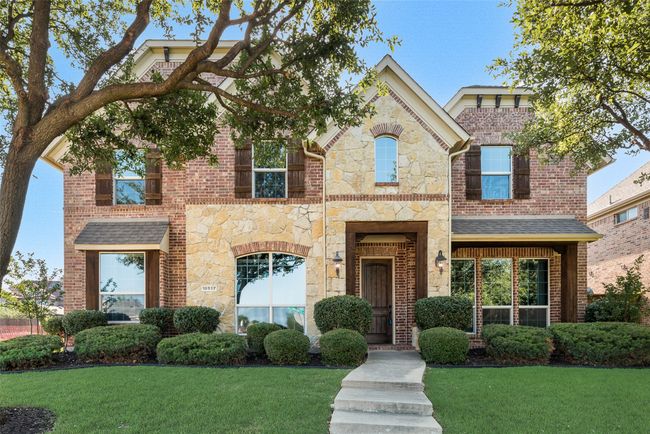 View of front of house with a front yard, stone siding, and brick siding | Image 4