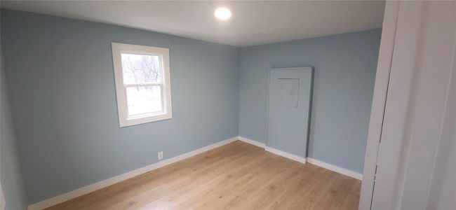 Spare room featuring light wood finished floors and baseboards | Image 31