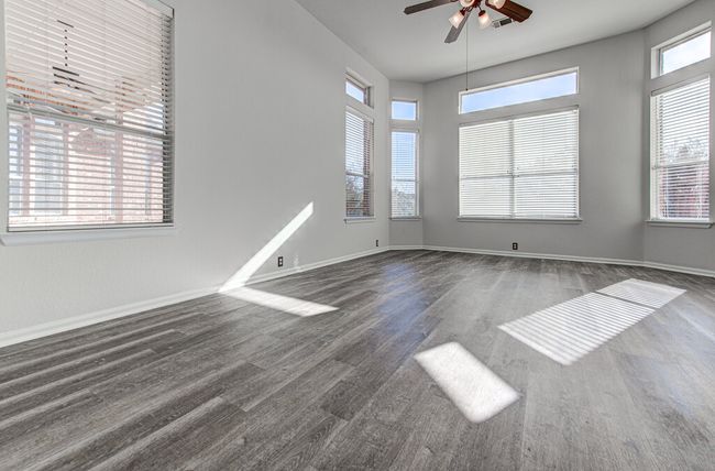 Empty room featuring wood finished floors, baseboards, and ceiling fan | Image 19
