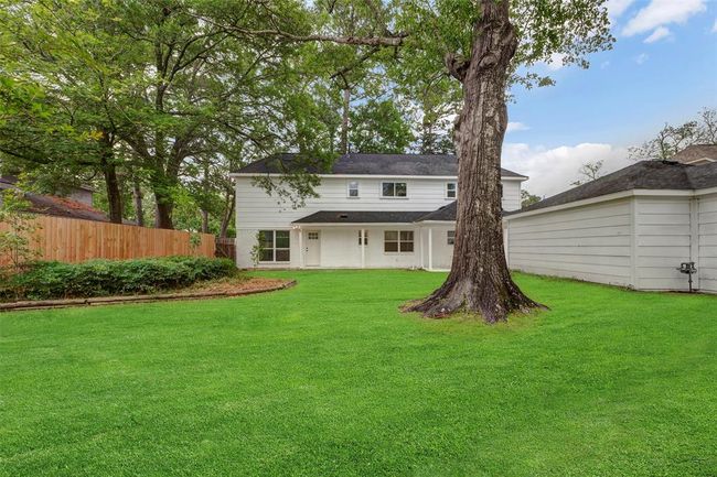 Enormous back yard with mature trees and oversized garage. | Image 37