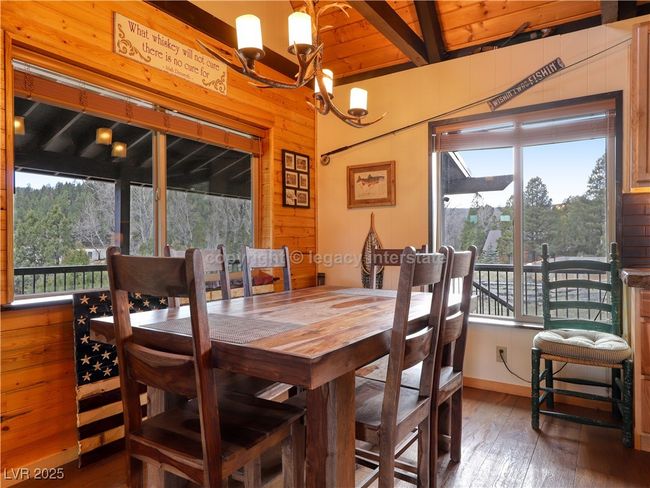 Dining room featuring a notable chandelier, plenty of natural light, and hardwood / wood-style floors | Image 15
