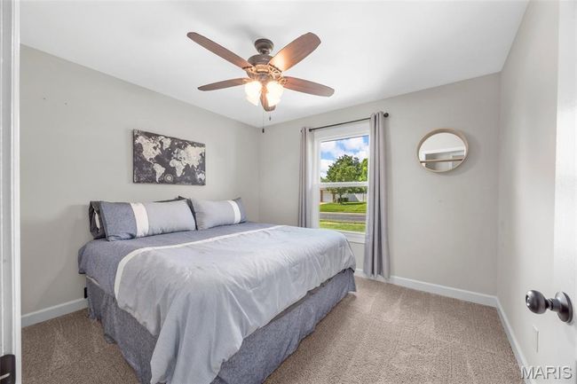 Bedroom with light colored carpet and ceiling fan | Image 21