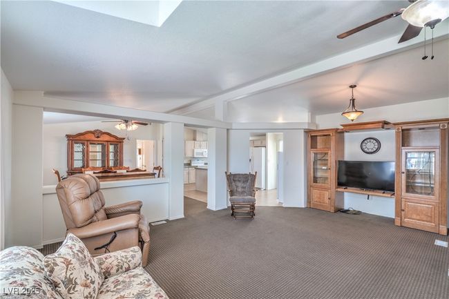 Carpeted living area with ceiling fan | Image 6