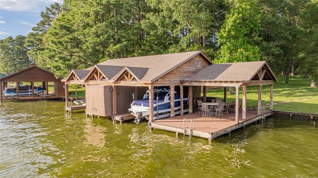 Dock featuring boat lift and a water view | Image 8