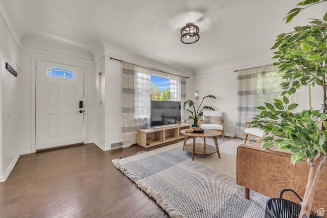 Living room with wood finished floors and baseboards | Image 6