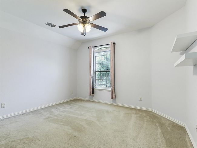 Carpeted spare room featuring ceiling fan and baseboards | Image 31