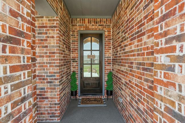 View of exterior entry with brick siding | Image 5