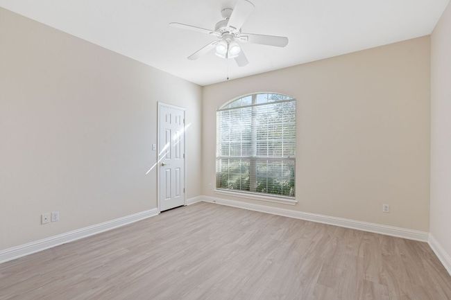 Spare room featuring baseboards, ceiling fan, and light wood-style floors | Image 26