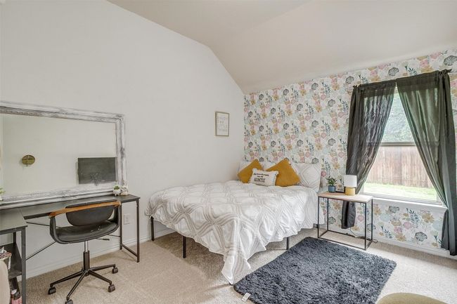 Bedroom featuring vaulted ceiling, carpet flooring, a desk, and wallpapered walls | Image 25