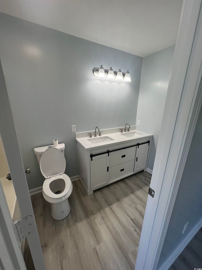 Bathroom featuring wood finished floors and double vanity | Image 7