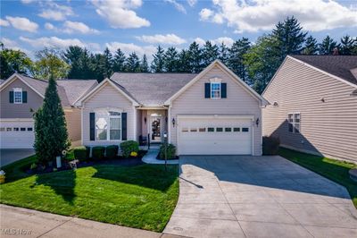 View of front of home with a garage and a front lawn | Image 1