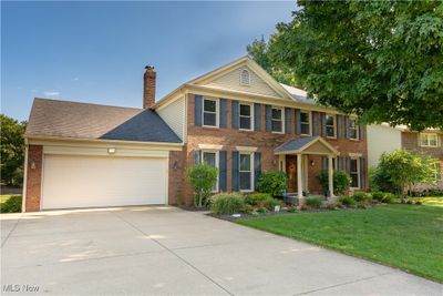 View of front of house featuring a front lawn and a garage | Image 1