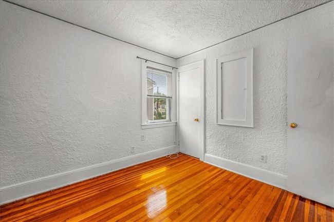 Unfurnished room with hardwood / wood-style flooring and a textured ceiling | Image 15