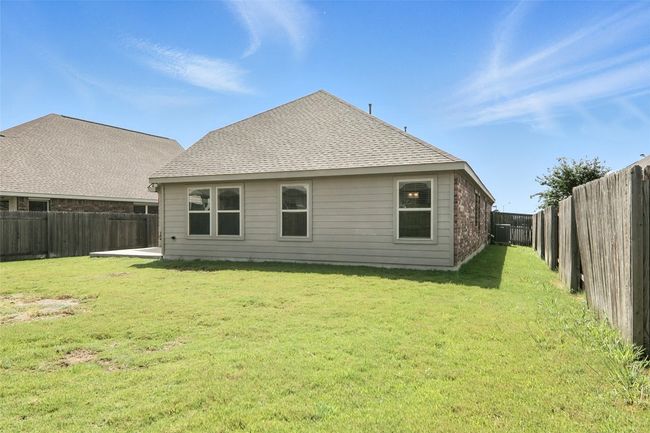 Back of house featuring a fenced backyard and a shingled roof | Image 35