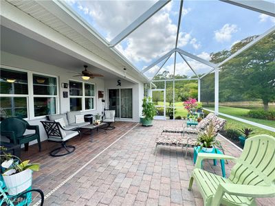 View of patio with glass enclosure and ceiling fan | Image 3