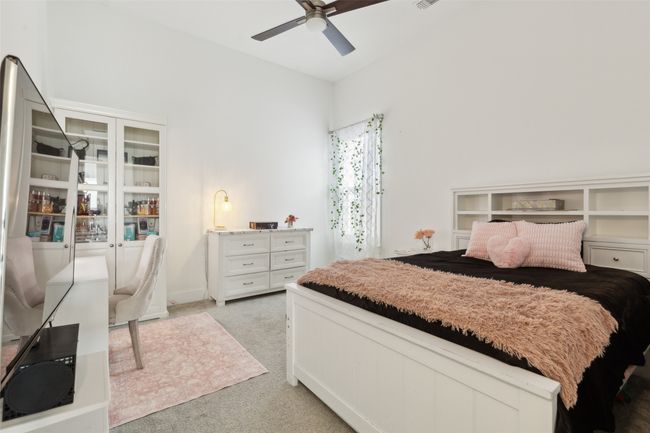 Bedroom with light carpet and a ceiling fan | Image 31