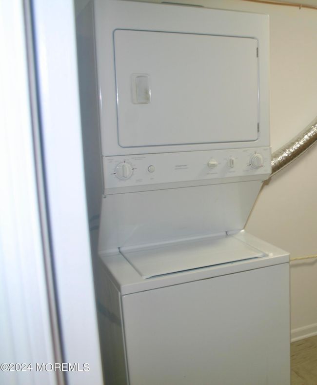 Stackable washer/dryer with additional storage in utility room | Image 9