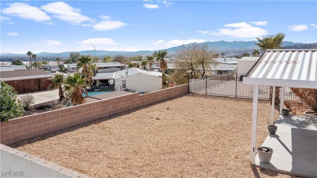 View of yard featuring a residential view, a fenced backyard, and a mountain view | Image 52
