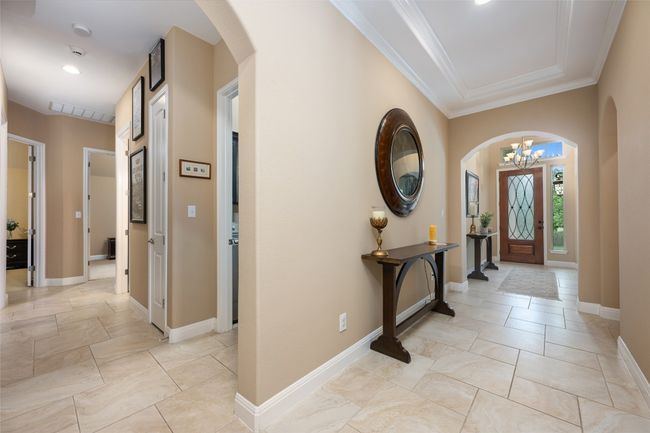 Foyer with a chandelier, arched walkways, ornamental molding, and recessed lighting | Image 26