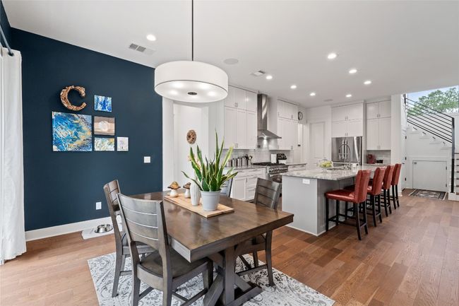 Dining space featuring stairs, light wood-type flooring, recessed lighting, and baseboards | Image 11
