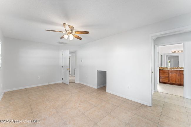En suite #1 and living space, small fridge fits in wall. | Image 76