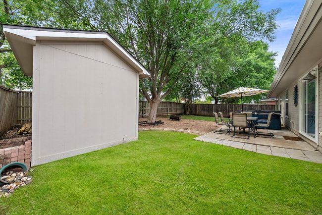 View of yard featuring a patio area and an outdoor structure | Image 28