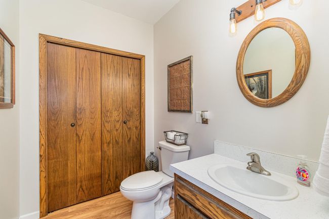 The main floor has a spacious 1/2 bathroom. It features a sizable storage closet & exhaust fan. | Image 21