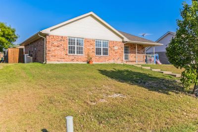 Rear view of house featuring cooling unit and a yard | Image 3