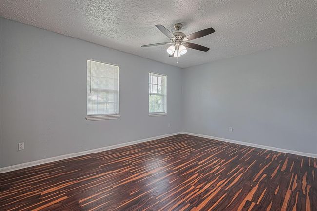 Bedroom #3 upstairs features laminate flooring and a very large walk-in closet with windows. | Image 28