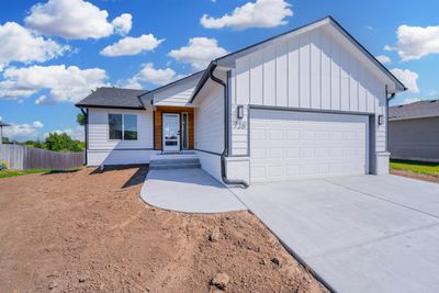 Modern farmhouse style home with a garage | Image 1