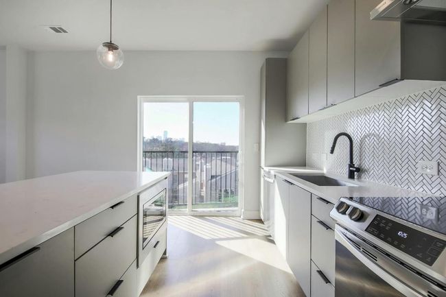 Modern Kitchen with quartz countertops & stainless steel appliances | Image 4