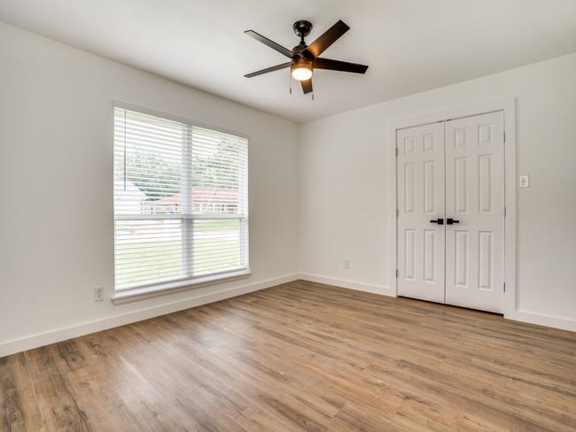 Unfurnished bedroom featuring light wood-style floors, baseboards, and a closet | Image 8