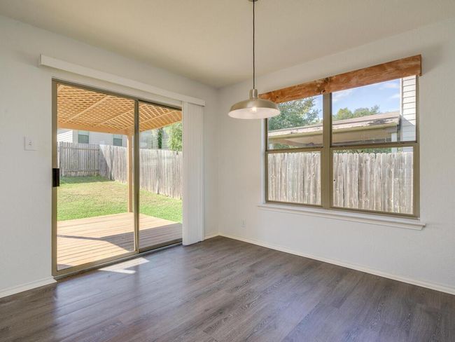 Unfurnished dining area with luxury vinyl wood-look flooring and lots of natural light. | Image 10