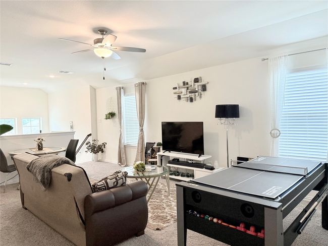 Carpeted living room with a ceiling fan and baseboards | Image 25