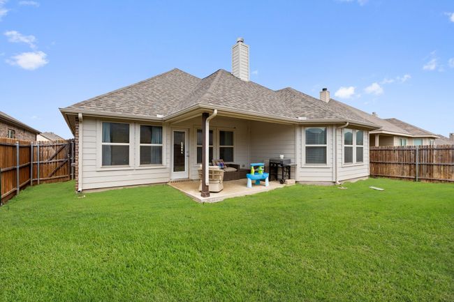Back of property featuring a shingled roof, a lawn, a fenced backyard, and a chimney | Image 28