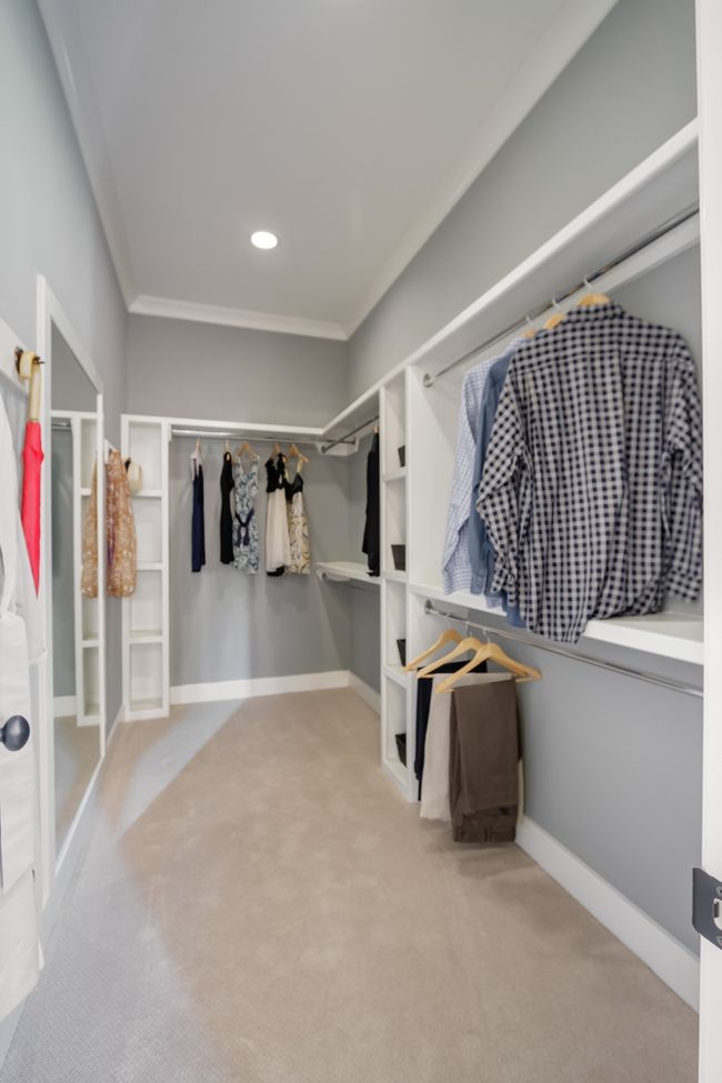 The primary closet is large and has plenty of room for clothes. | Image 39