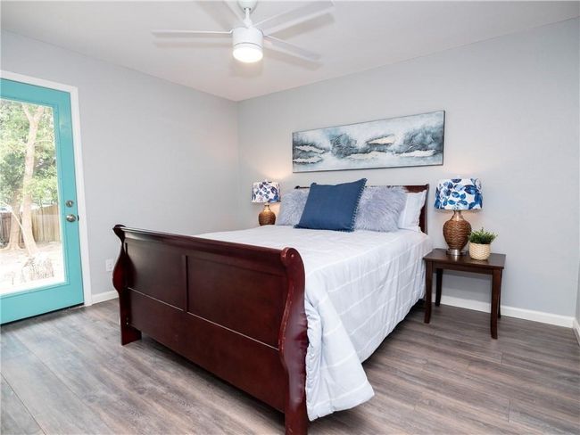 Bedroom with wood finished floors, access to exterior, and ceiling fan | Image 4