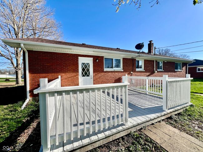 exterior space featuring a chimney, a deck, and brick siding | Image 27